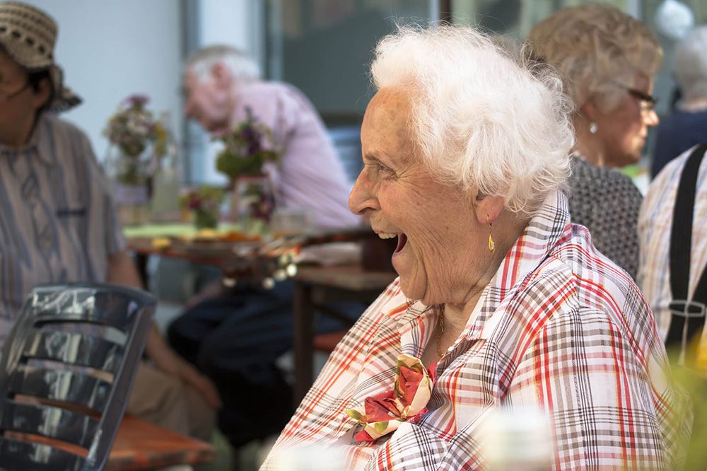 Ältere Frau lacht aus vollem Herzen.